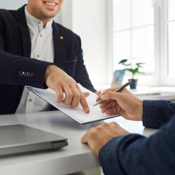Man pointing to a blank space to sign