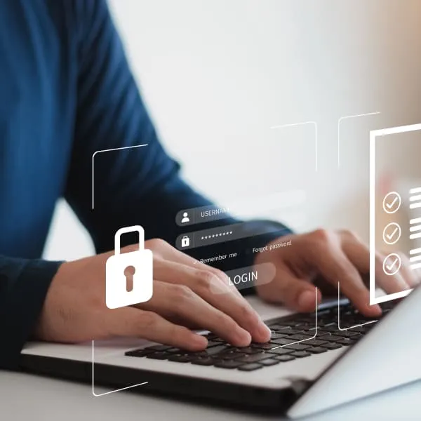 Image showing a person updating firewall settings on a computer to protect business from cyber attacks.